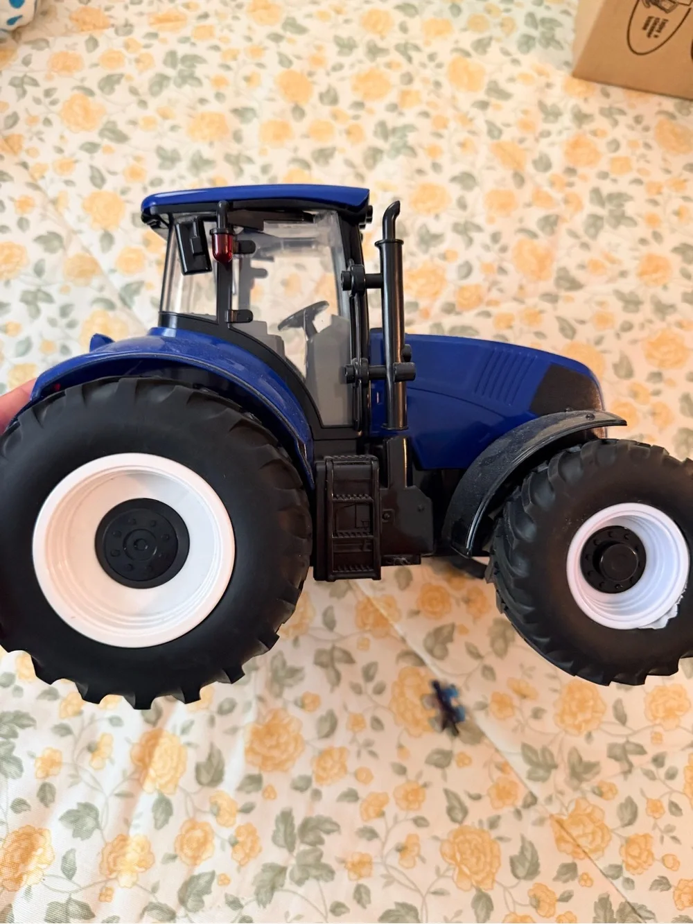 Medium plastic blue and black electronic toy tractor, lights up with sound